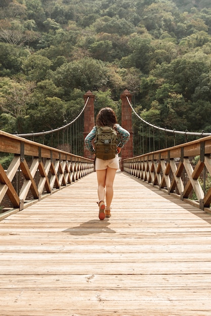 Front view woman crossing bridge