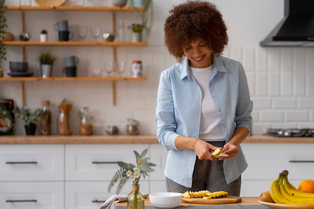 front view woman cutting banana