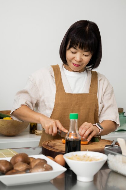 Front view woman cutting vegetables