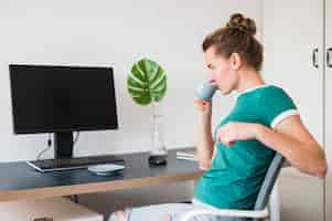 Free photo front view of woman at desk with copy space