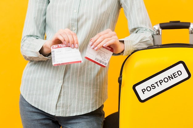 Free photo front view woman destroying her plane ticket