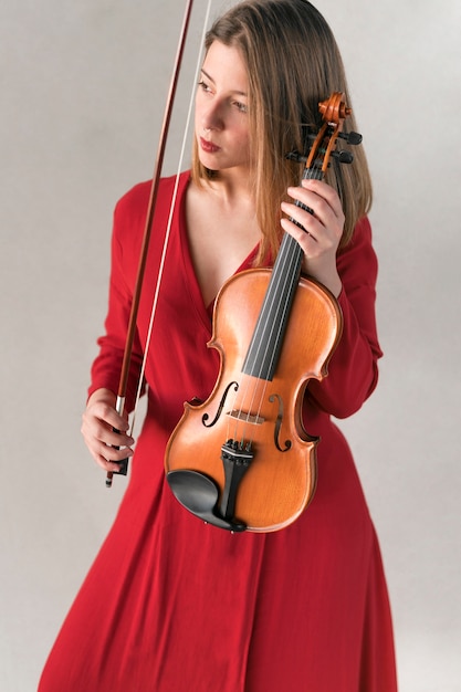 ヴァイオリンを保持しているドレスを着た女性の正面図