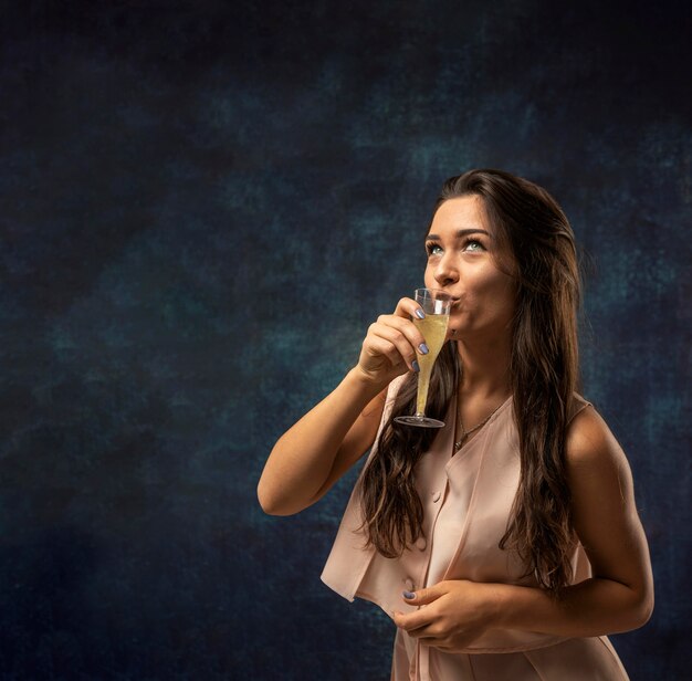 Front view of woman drinking champagne