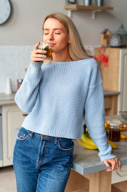 Front view woman drinking kombucha