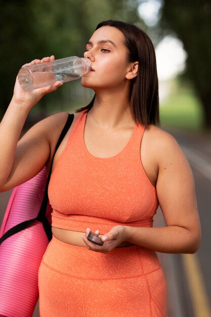 Front view woman drinking water