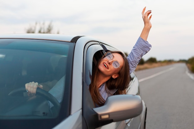 Front view of woman driving and having fun