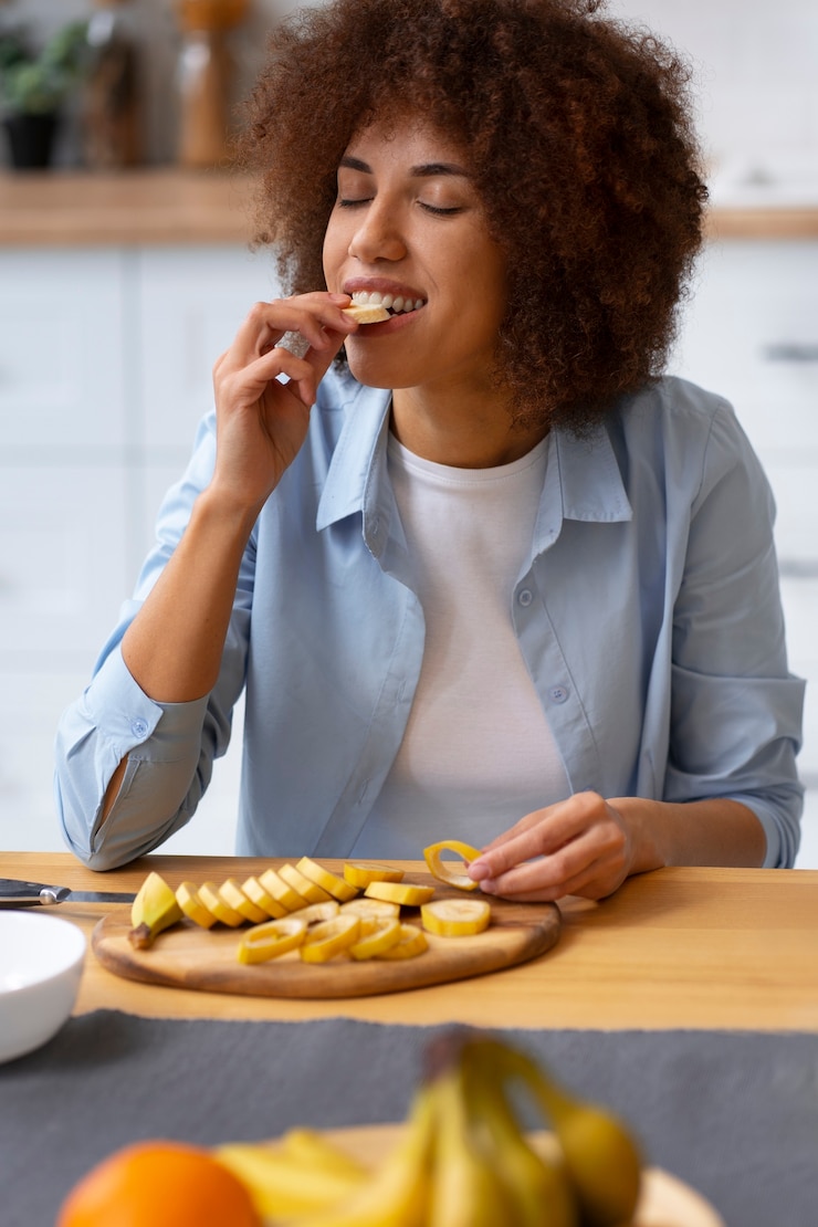 Free Photo front view woman eating banana