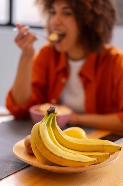 front view woman eating banana