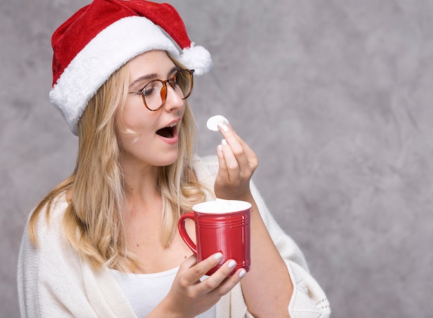 Front view woman eating marshmallow  