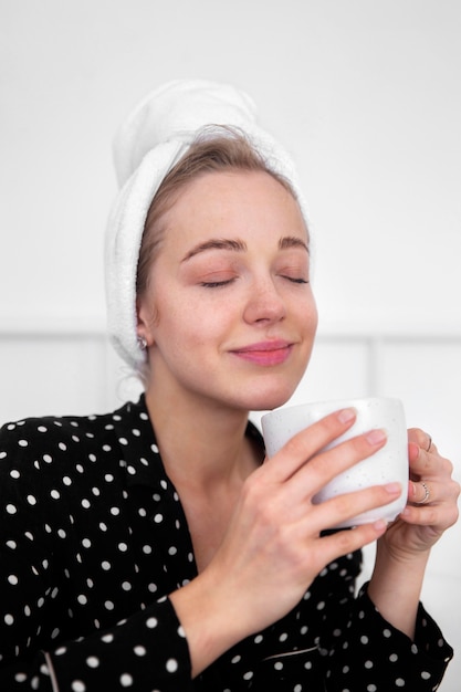 Front view of woman enjoying coffee