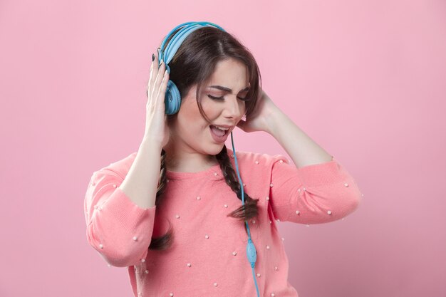 front view of woman enjoying listening to music on headphones