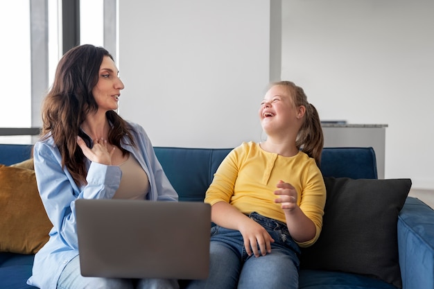 Front view woman and girl on couch