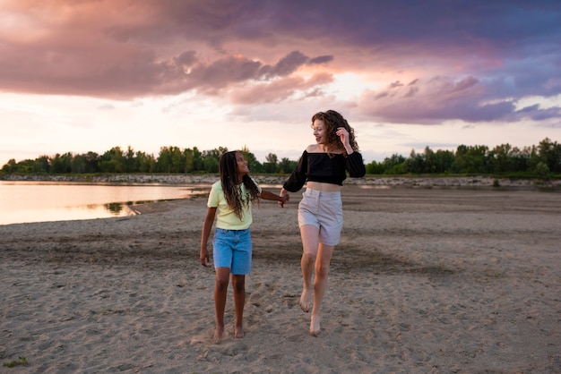 Free photo front view woman and girl holding hands