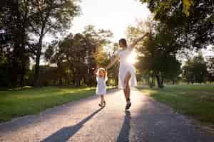 Free photo front view woman and girl holding hands