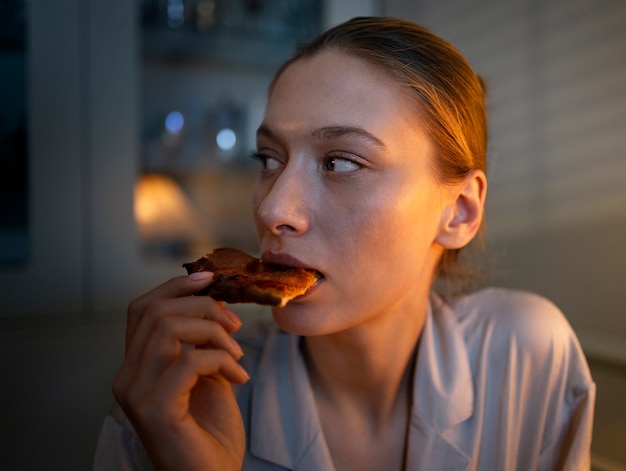 Front view woman having snacks at night