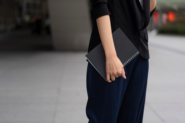 Front view of woman holding an agenda