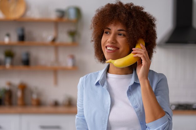 front view woman holding banana