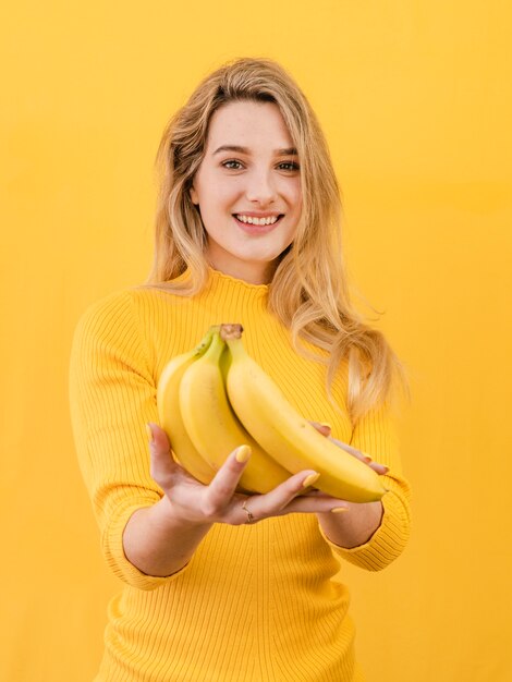 Front view woman holding bananas