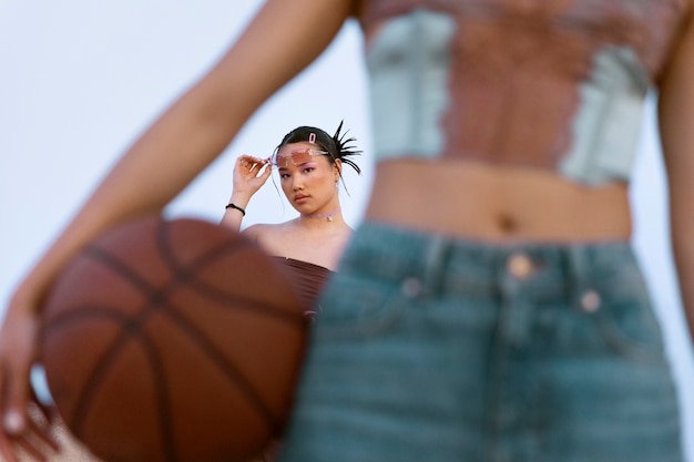 Free photo front view woman holding basket ball