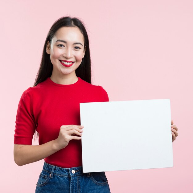 Front view woman holding blank paper sheet