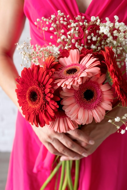 Front view of woman holding bouquet of flowers