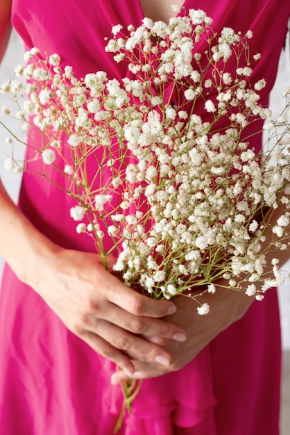 Front view of woman holding bouquet of flowers