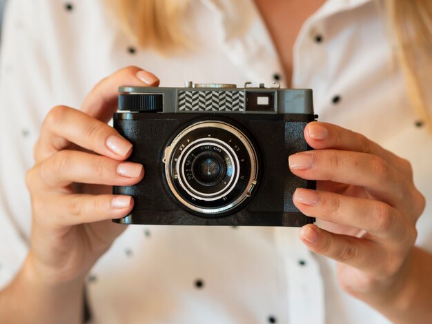 Front view woman holding camera