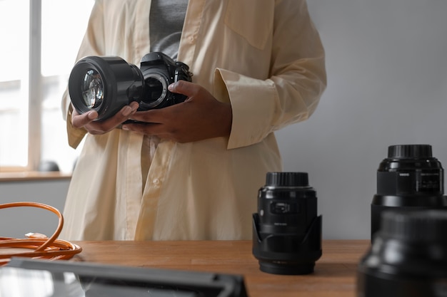 Foto gratuita macchina fotografica della tenuta della donna di vista frontale