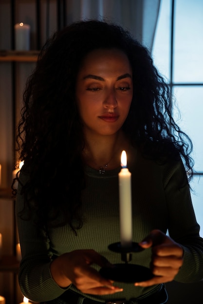 Front view woman holding candle