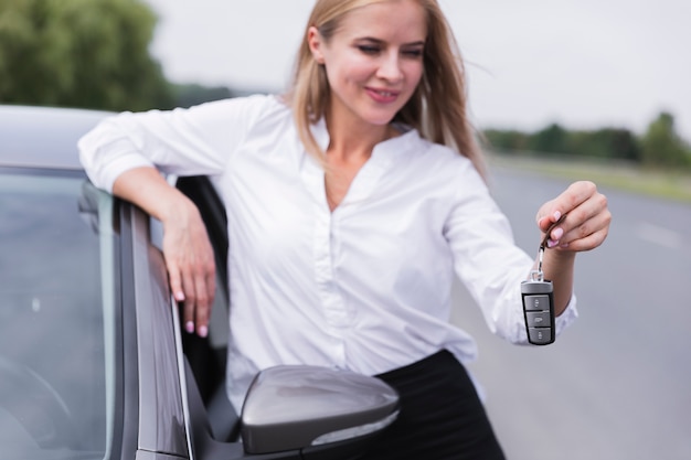 Front view of woman holding car keys
