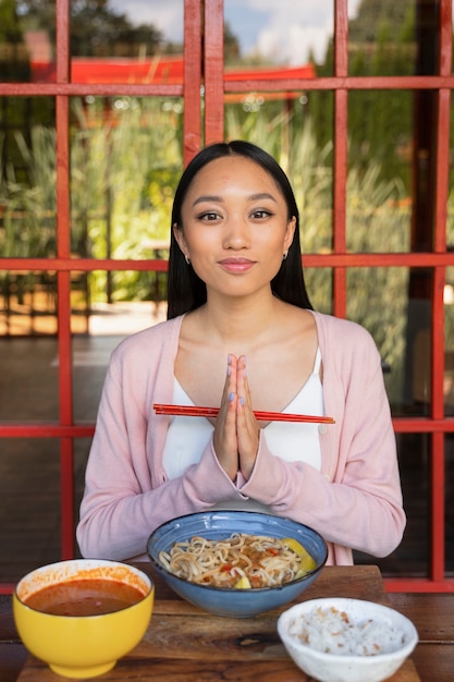 Front view woman holding chopsticks