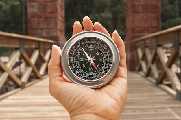 Front view woman holding compass