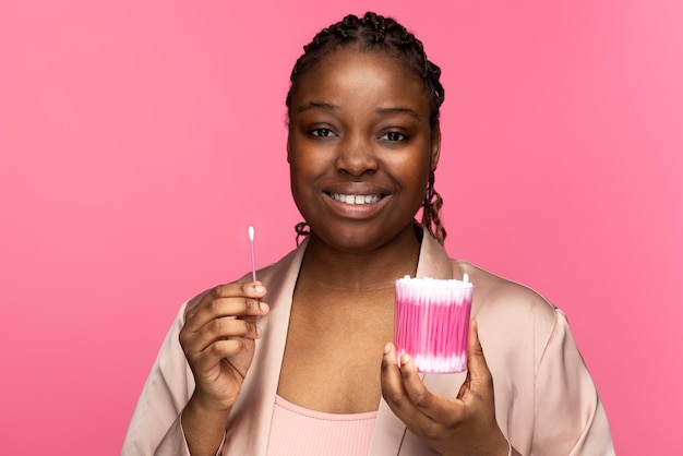 Free photo front view woman holding cotton swabs