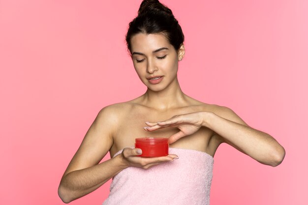 Front view woman holding cream container