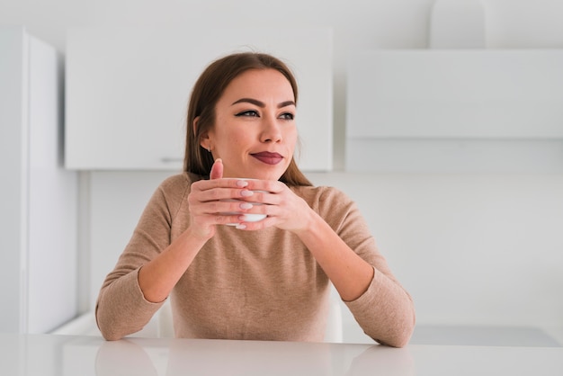 Front view woman holding a cup of coffee