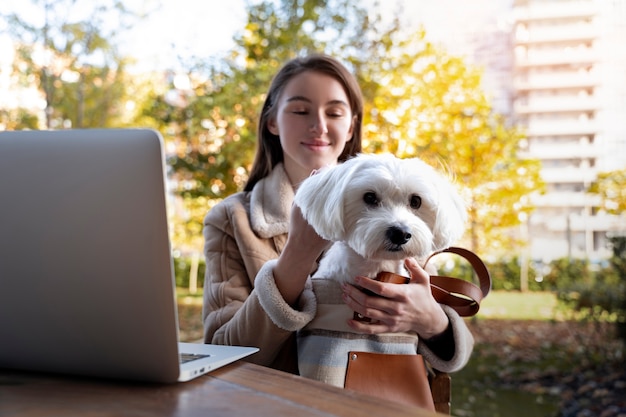 Free photo front view woman holding cute dog