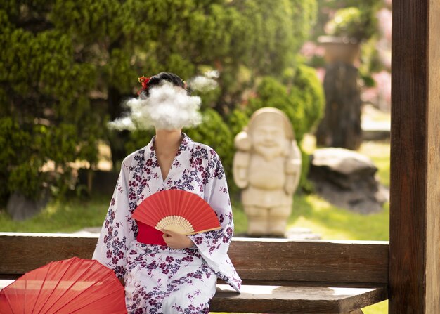 Front view woman holding fan