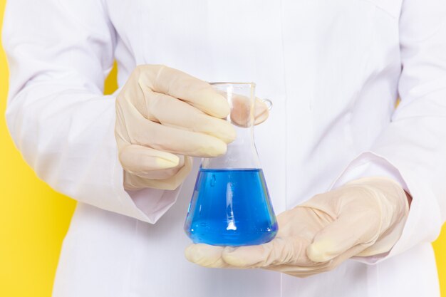 Front view of woman holding flask with chemical solution