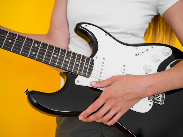 Free photo front view of woman holding guitar