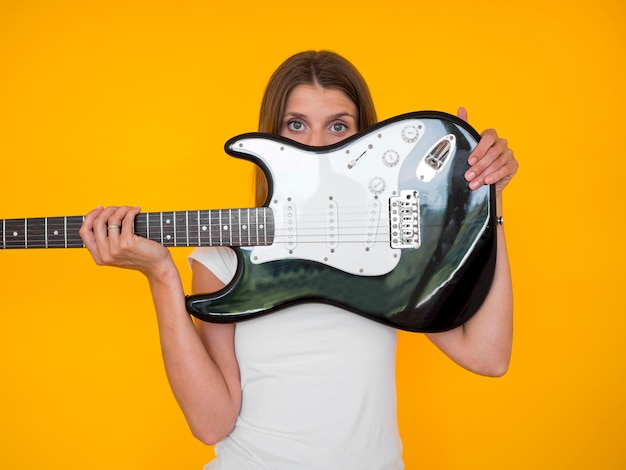 Free photo front view of woman holding guitar