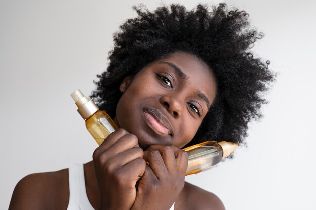 Front view woman holding hair products