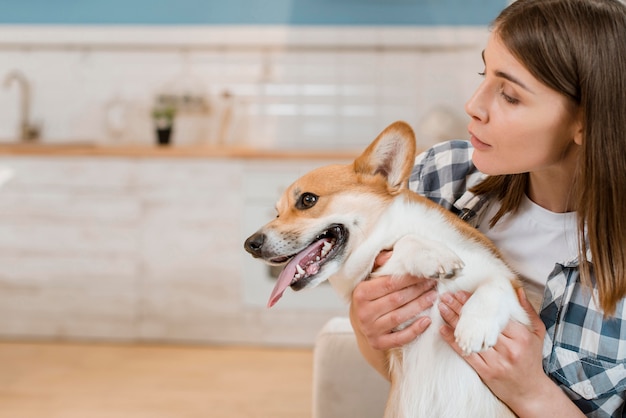 Front view of woman holding her adorable dog