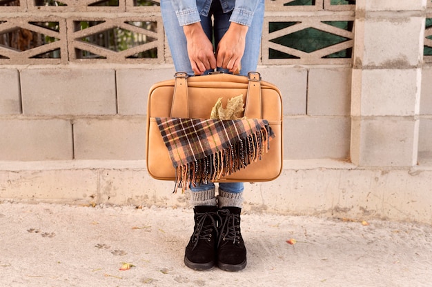 Free photo front view woman holding her baggage