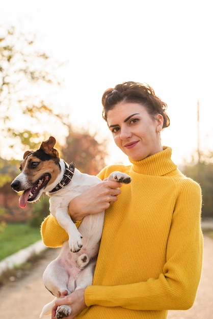 Front view woman holding her dog