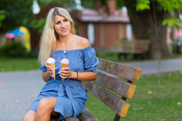 Front view of woman holding ice cream cones
