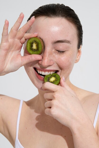 Front view woman holding kiwi