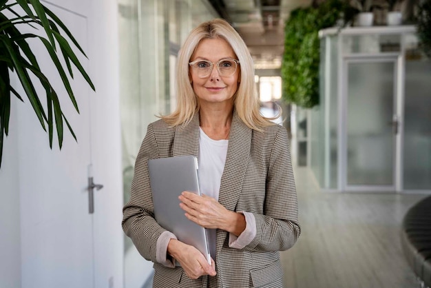 Free photo front view woman holding laptop