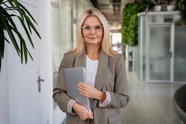 Front view woman holding laptop