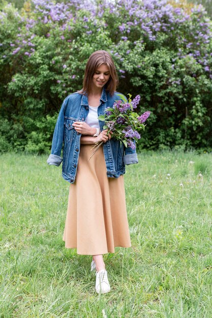 Front view woman holding lilac branches