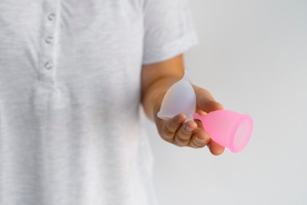 Front view woman holding menstrual cups